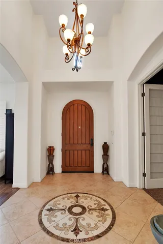 a view of a hallway with a chandelier and livingroom