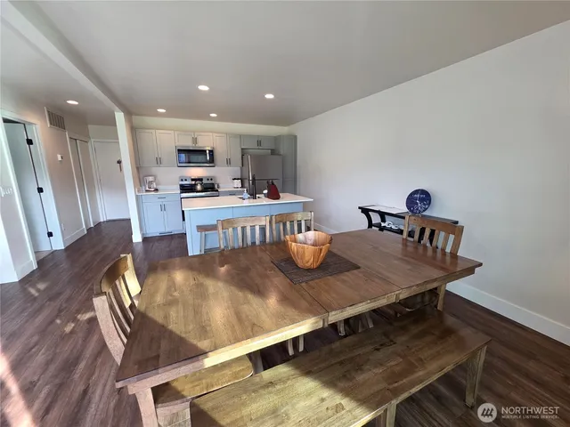 a living room with kitchen island furniture and a wooden floor