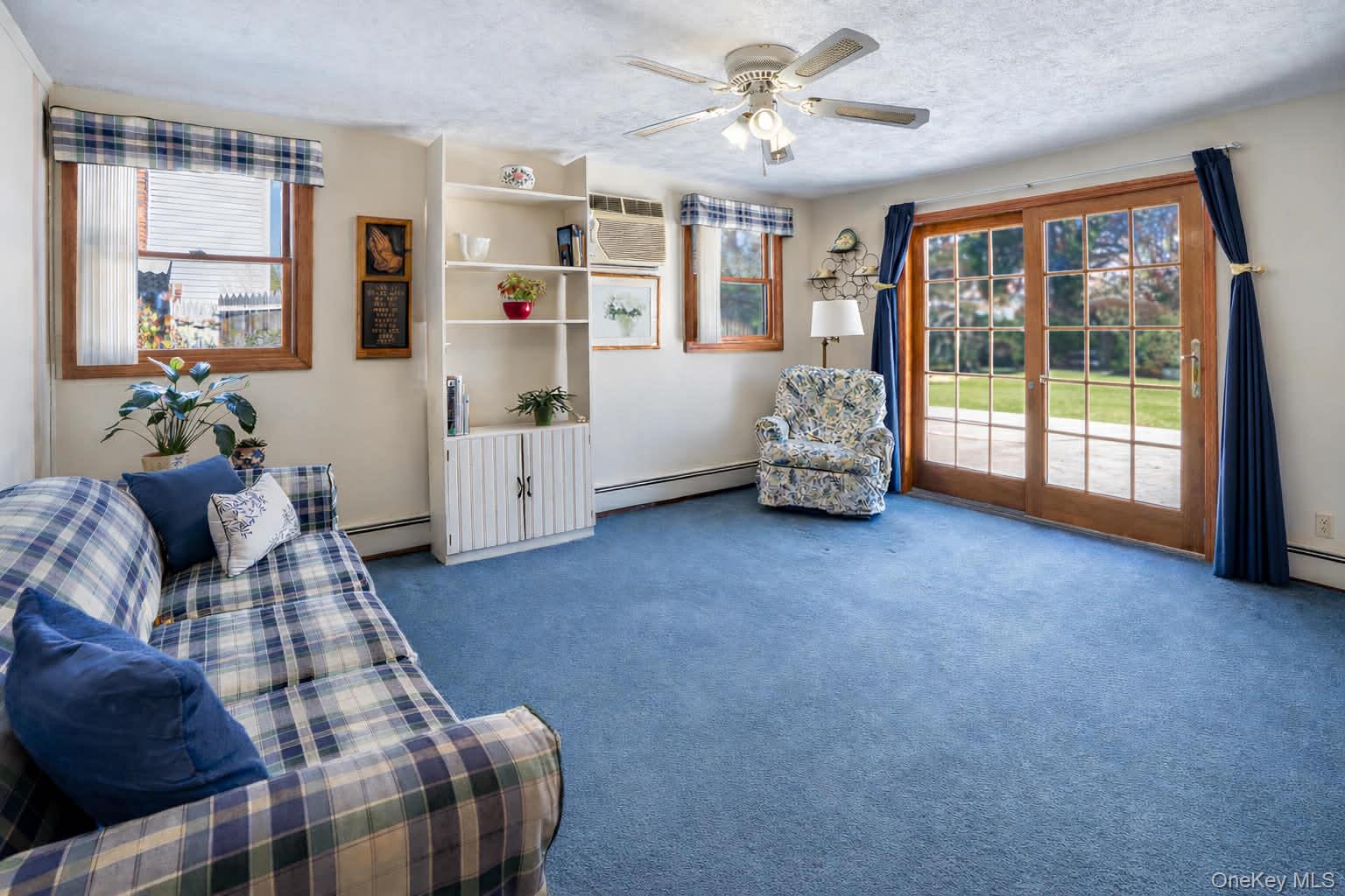 69 Riviera Drive Selden, NY 11784 - Photo 12 of 20 a living room with furniture and a large window