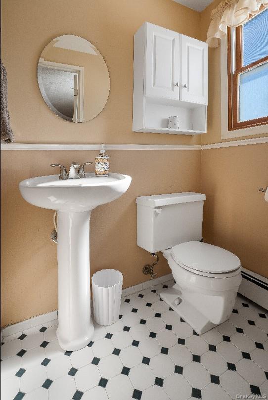 69 Riviera Drive Selden, NY 11784 - Photo 15 of 20 a bathroom with a sink a toilet and a mirror