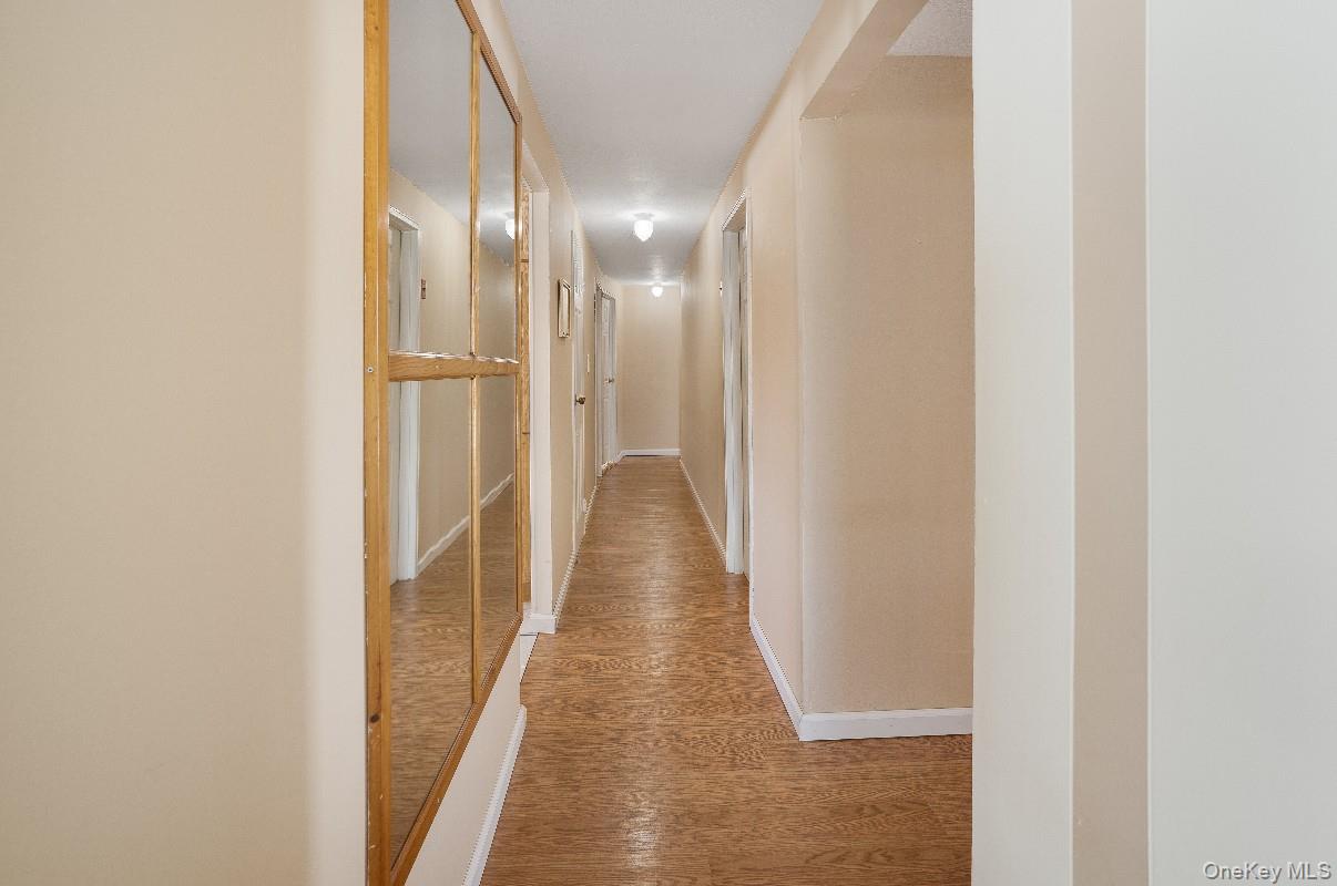 69 Riviera Drive Selden, NY 11784 - Photo 3 of 20 a view of a hallway with wooden floor