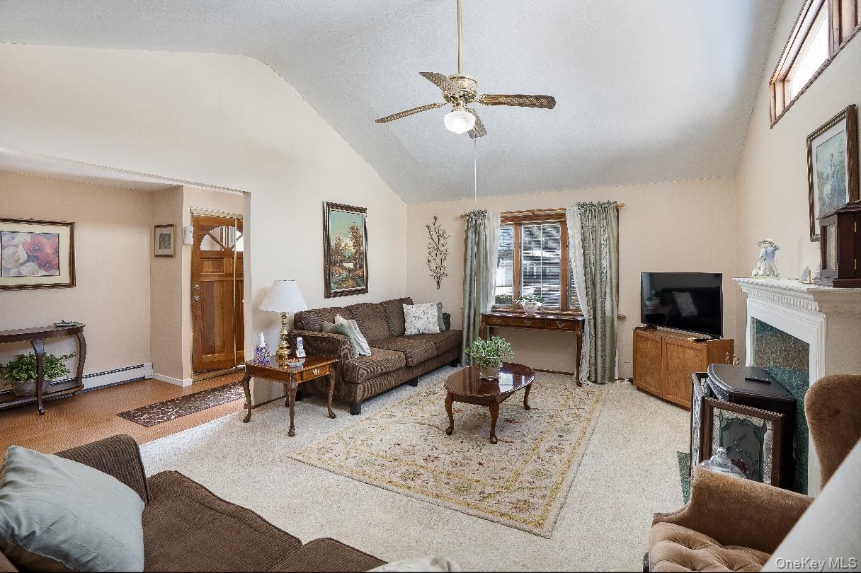 69 Riviera Drive Selden, NY 11784 - Photo 4 of 20 a living room with furniture or couch and a flat screen tv