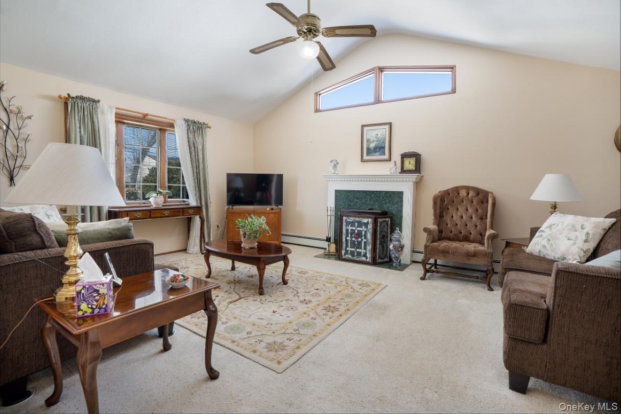 69 Riviera Drive Selden, NY 11784 - Photo 6 of 20 a living room with furniture and a fireplace