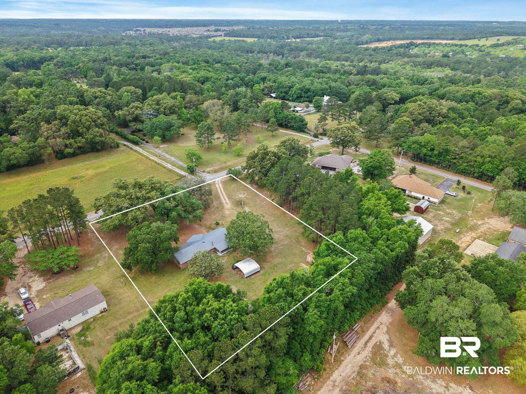 13653 Roberts Road Loxley, AL 36551 - Photo 31 of 33 Expansive wooded lot featuring a single-story residence with a gray roof