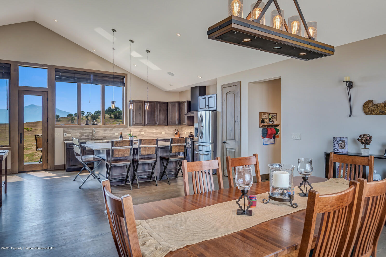 1009 Cattle Creek Ridge Road Carbondale, CO 81623 - Photo 12 of 40 a dining room with furniture a chandelier and wooden floor