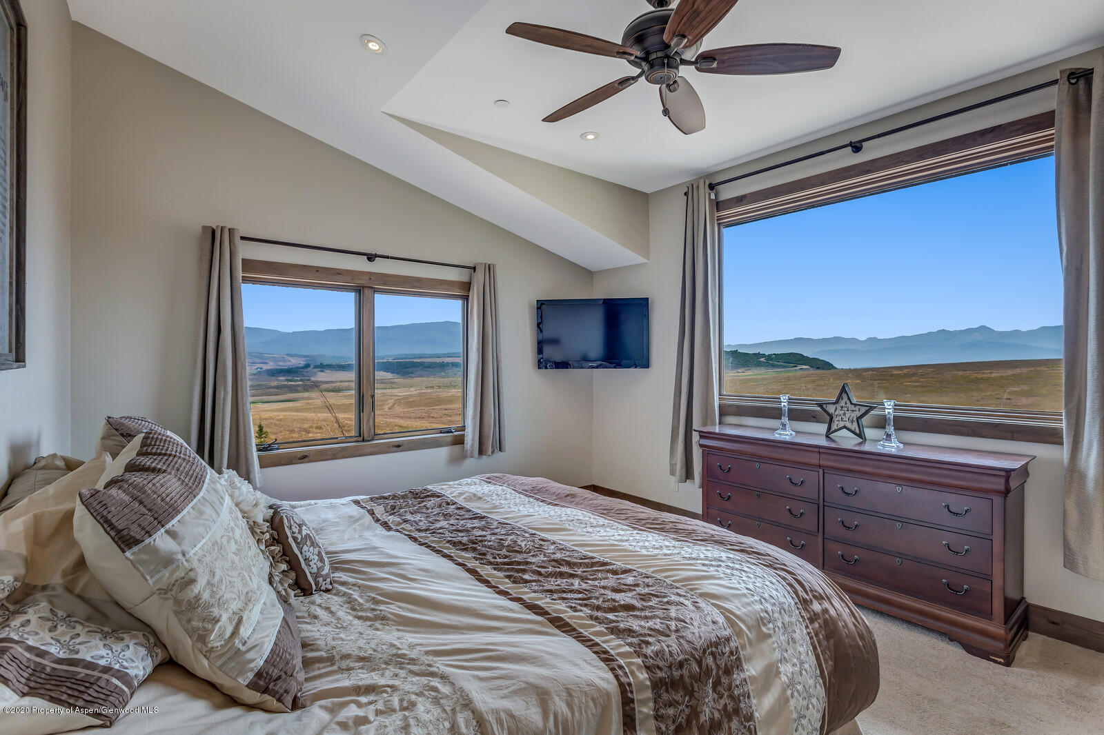 1009 Cattle Creek Ridge Road Carbondale, CO 81623 - Photo 14 of 40 a bedroom with a large bed and a large window