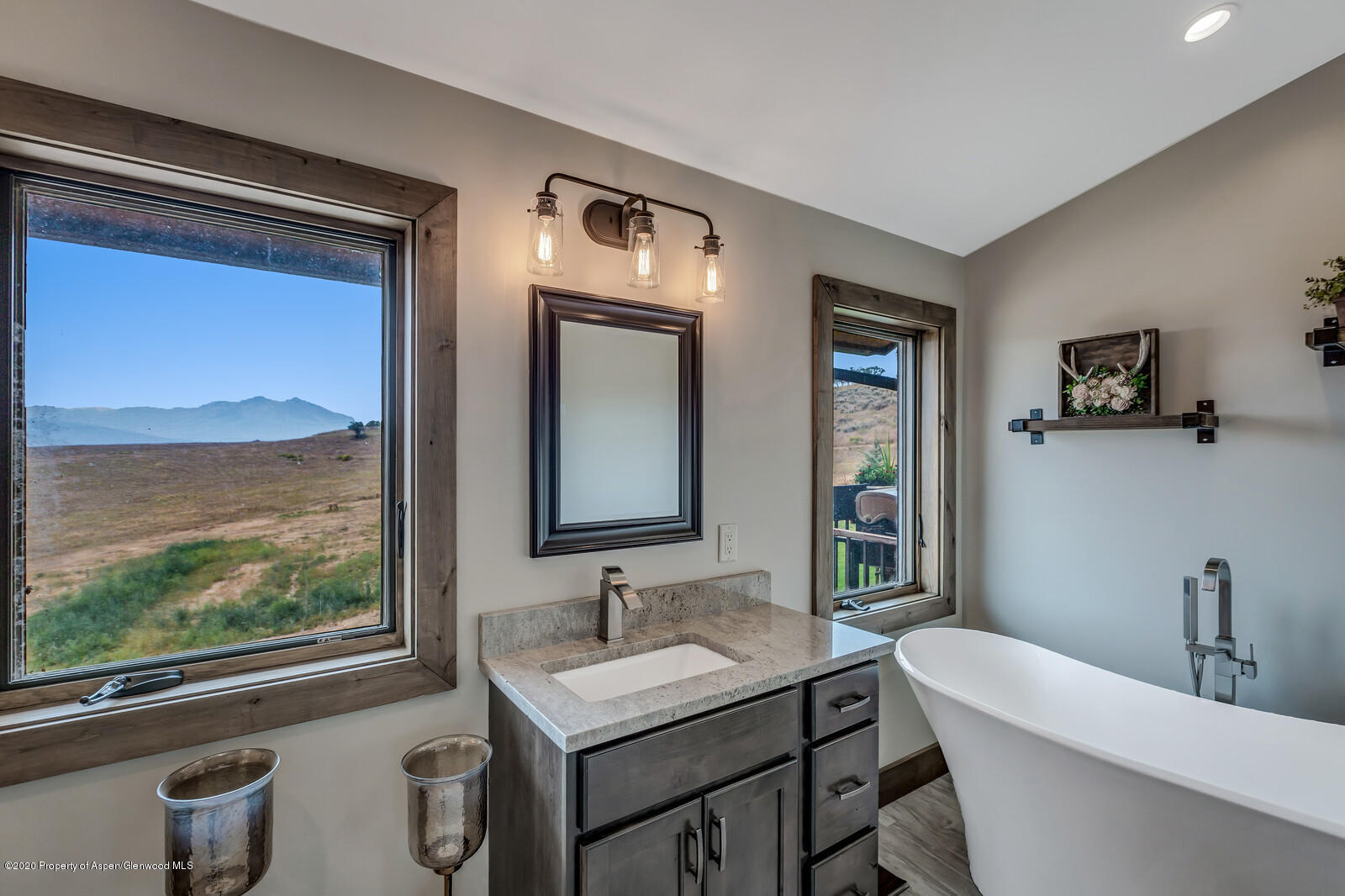 1009 Cattle Creek Ridge Road Carbondale, CO 81623 - Photo 19 of 40 a bathroom with a granite countertop sink mirror and a bathtub