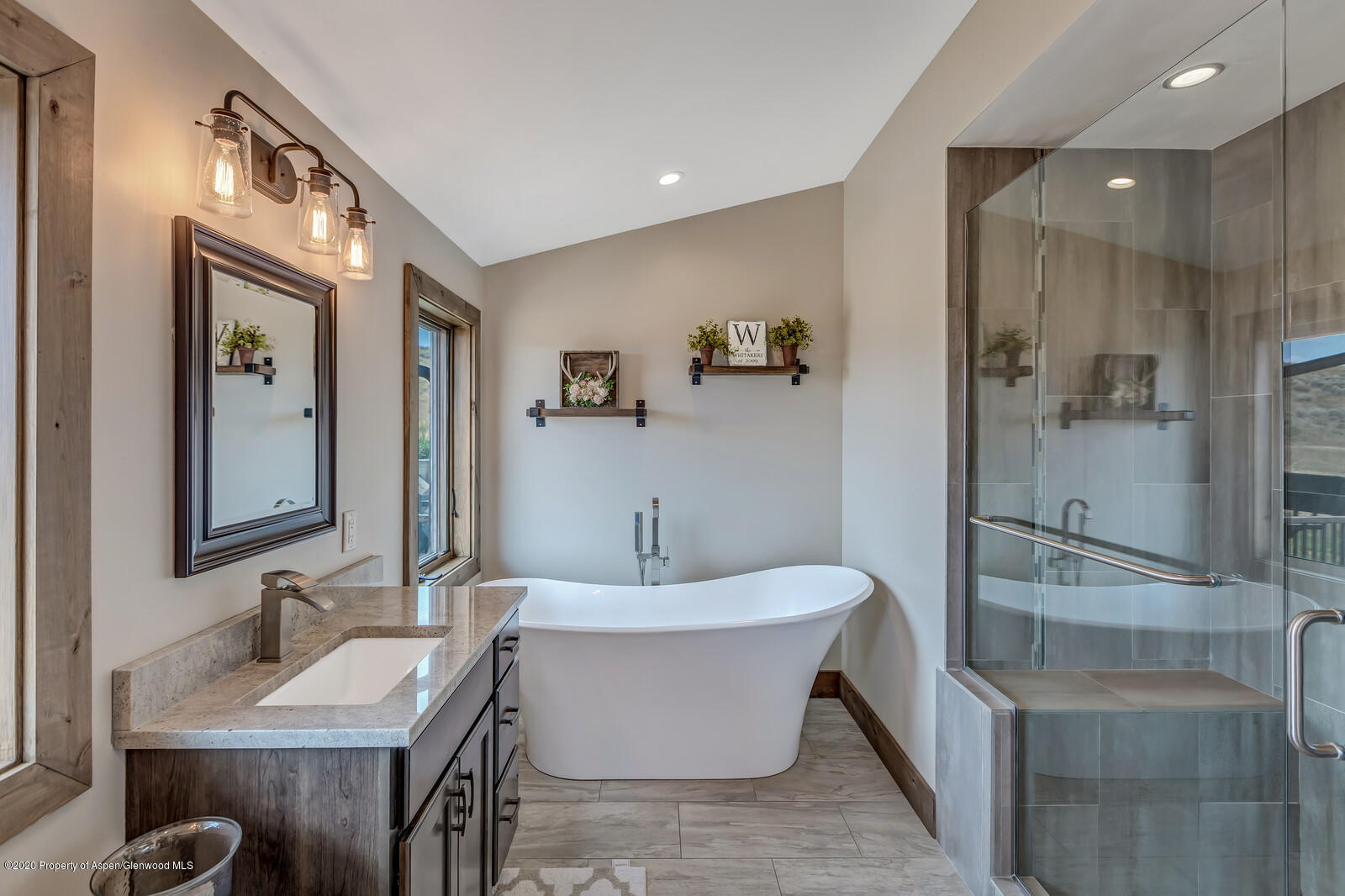 1009 Cattle Creek Ridge Road Carbondale, CO 81623 - Photo 20 of 40 a bathroom with a bathtub sink and mirror