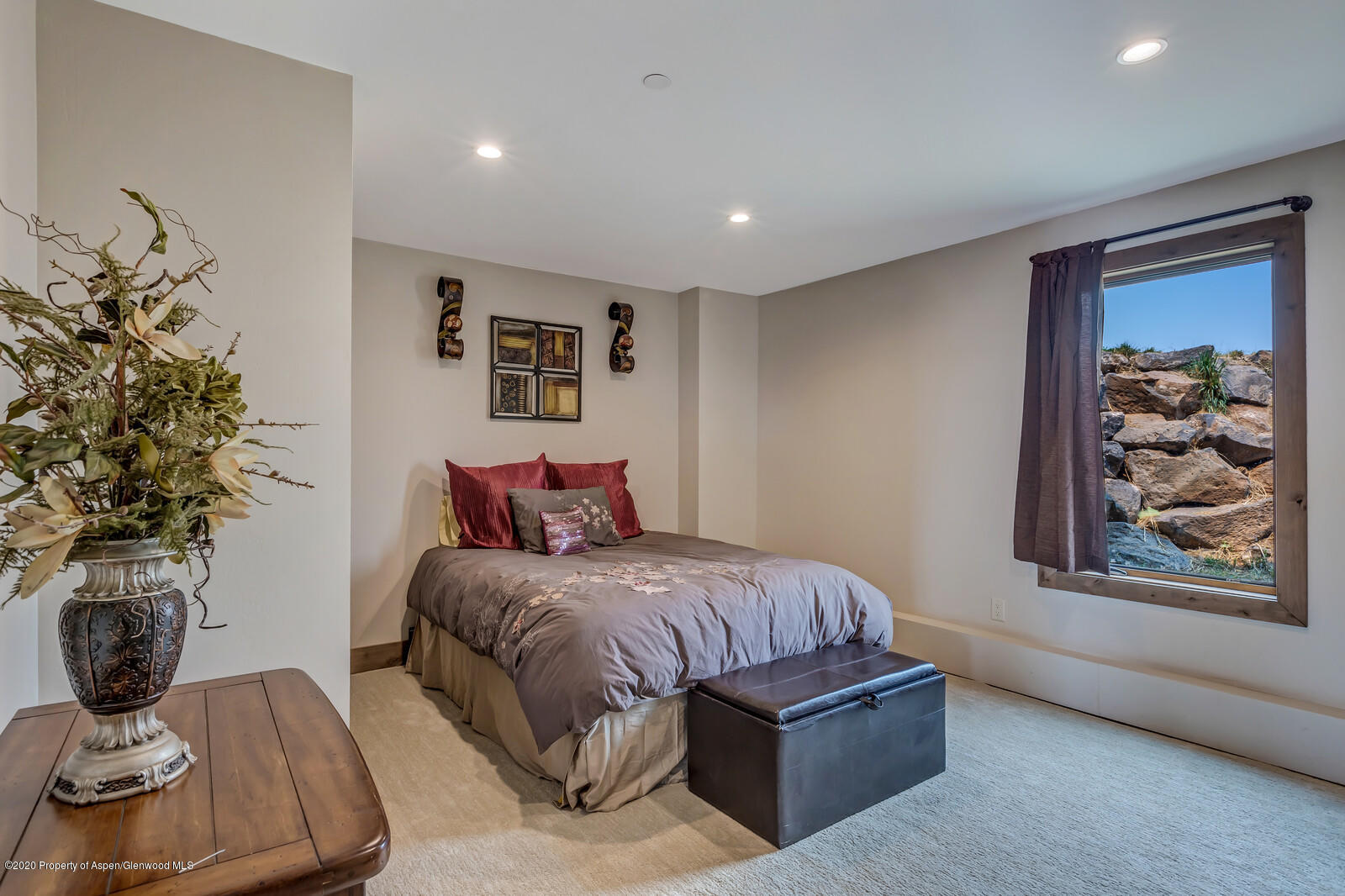 1009 Cattle Creek Ridge Road Carbondale, CO 81623 - Photo 25 of 40 a bedroom with a large bed and a potted plant