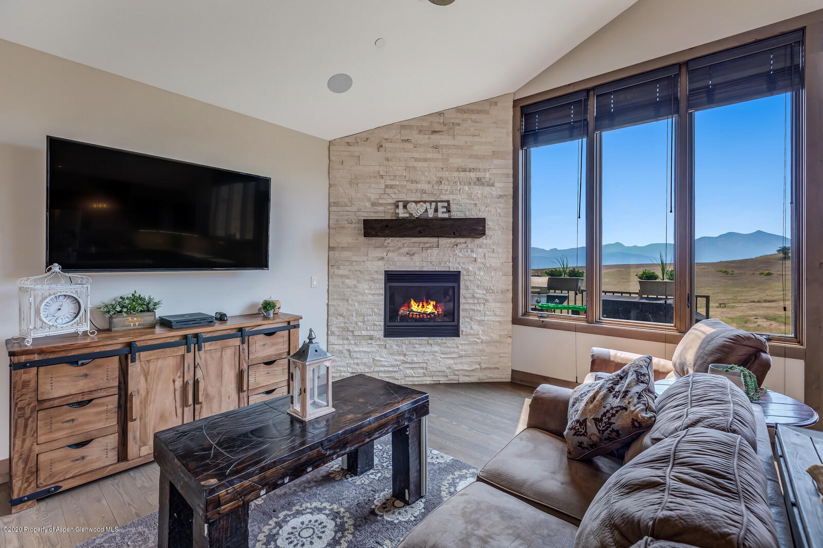 1009 Cattle Creek Ridge Road Carbondale, CO 81623 - Photo 3 of 40 a living room with furniture and a flat screen tv