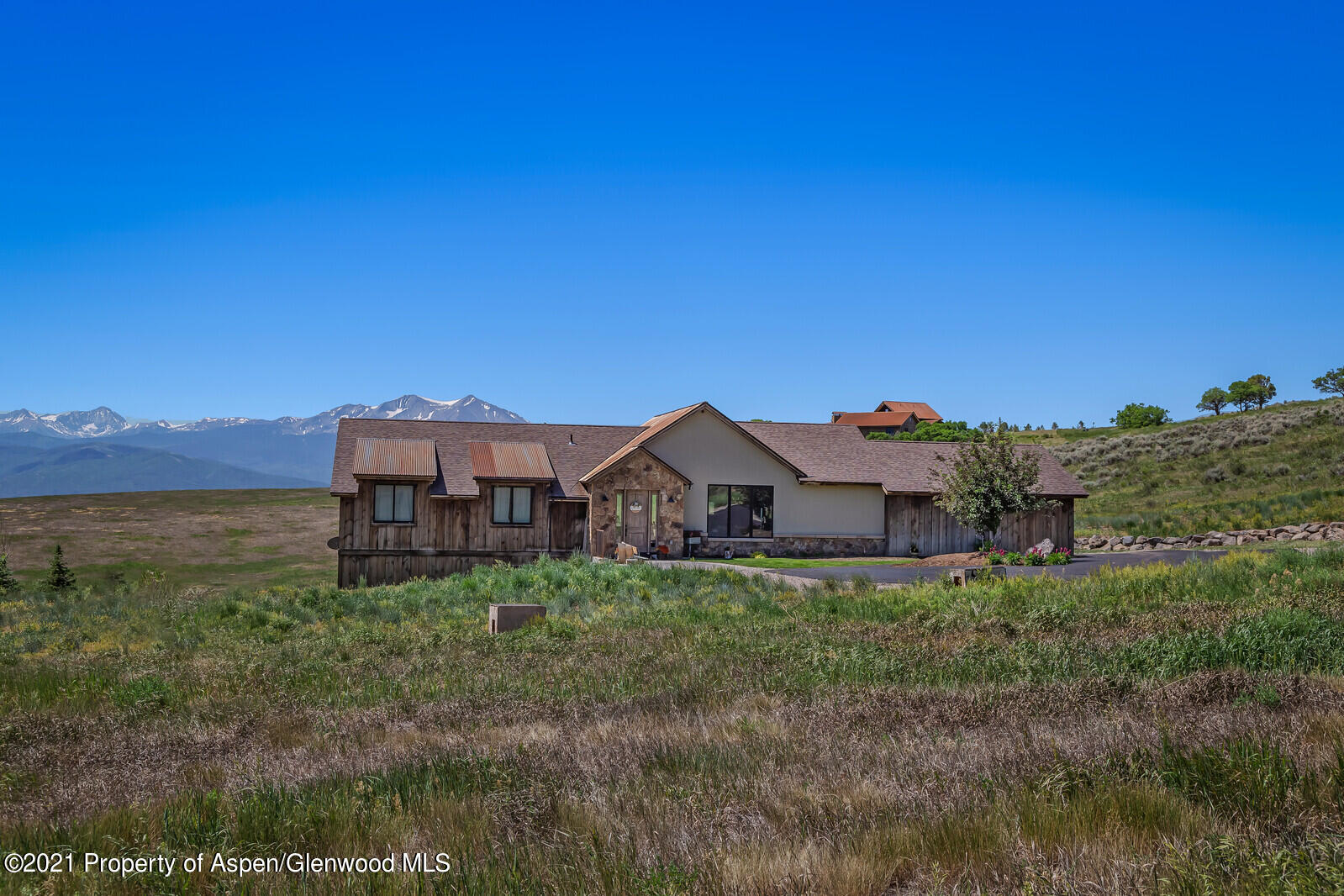 1009 Cattle Creek Ridge Road Carbondale, CO 81623 - Photo 33 of 40 a view of a house with a big yard and large trees