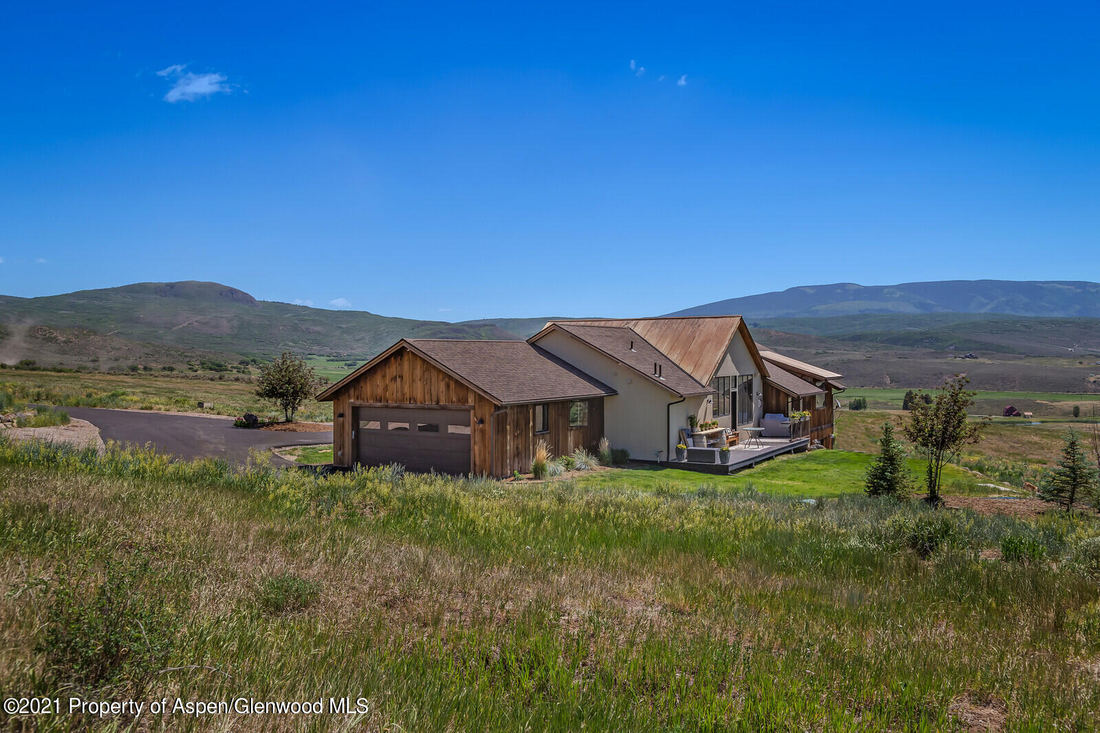 1009 Cattle Creek Ridge Road Carbondale, CO 81623 - Photo 34 of 40 a view of a house with a big yard and large tree