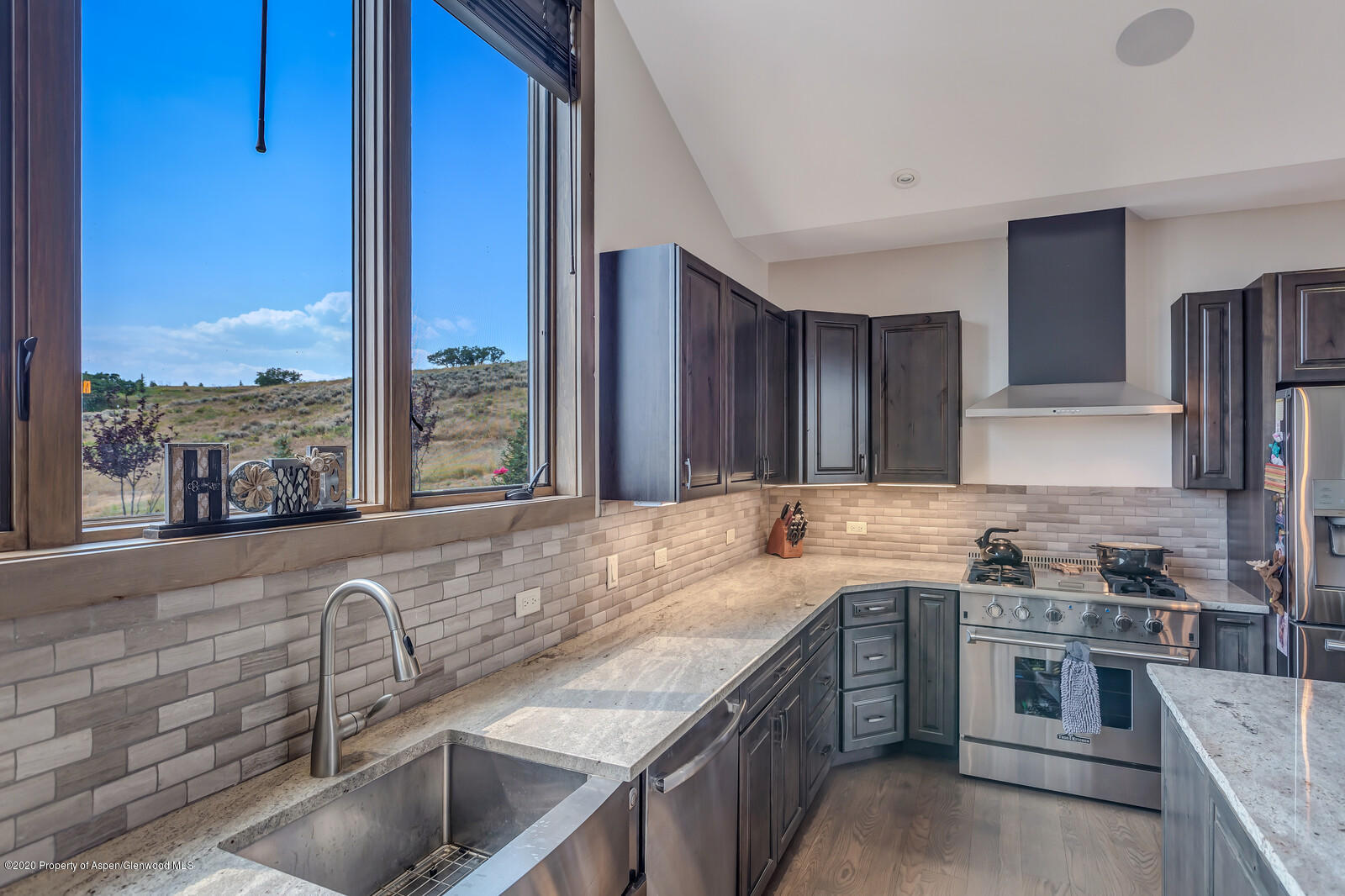 1009 Cattle Creek Ridge Road Carbondale, CO 81623 - Photo 7 of 40 a kitchen with a sink stove top oven and cabinets