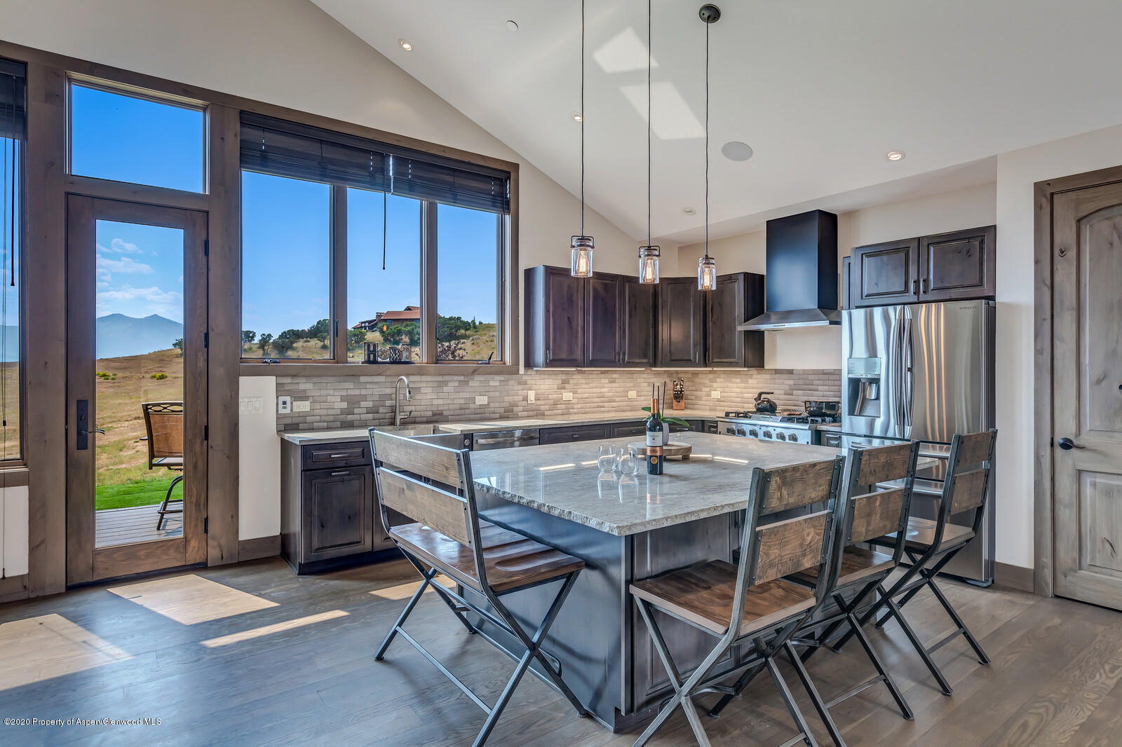 1009 Cattle Creek Ridge Road Carbondale, CO 81623 - Photo 9 of 40 a kitchen with stainless steel appliances granite countertop a stove refrigerator and a wooden cabinets