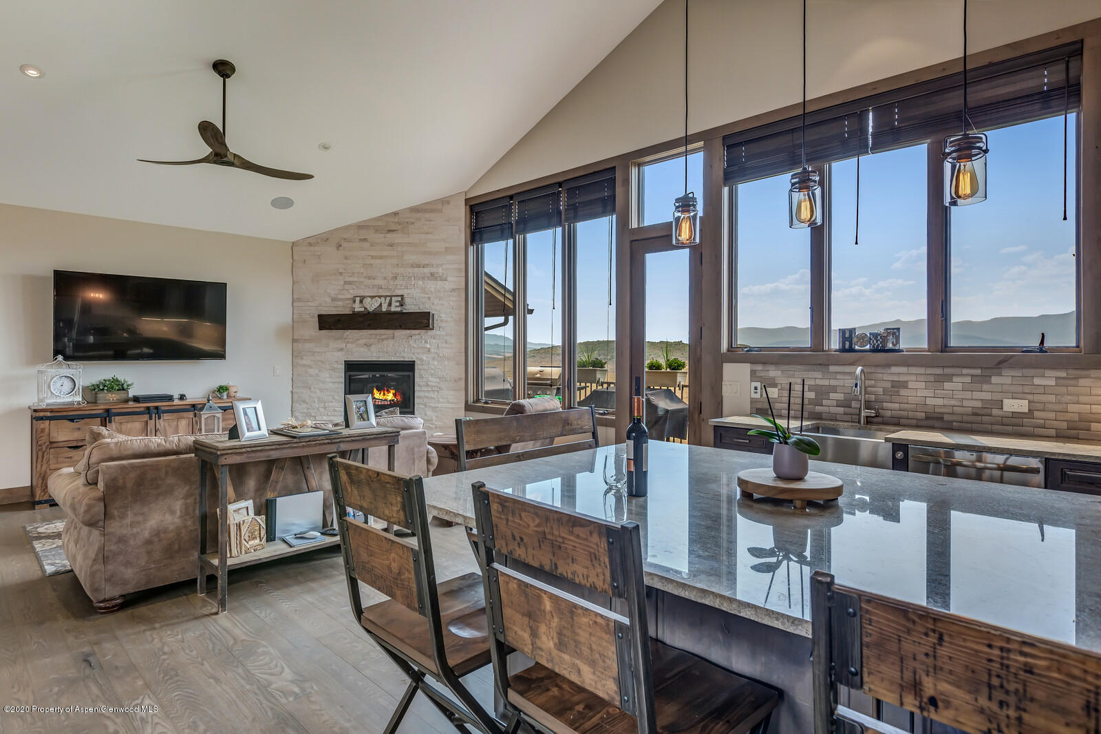 1009 Cattle Creek Ridge Road Carbondale, CO 81623 - Photo 10 of 40 a large kitchen with a table chairs stove and flat screen tv