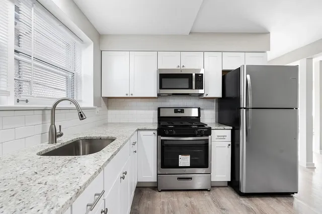 a kitchen with a sink stove and refrigerator