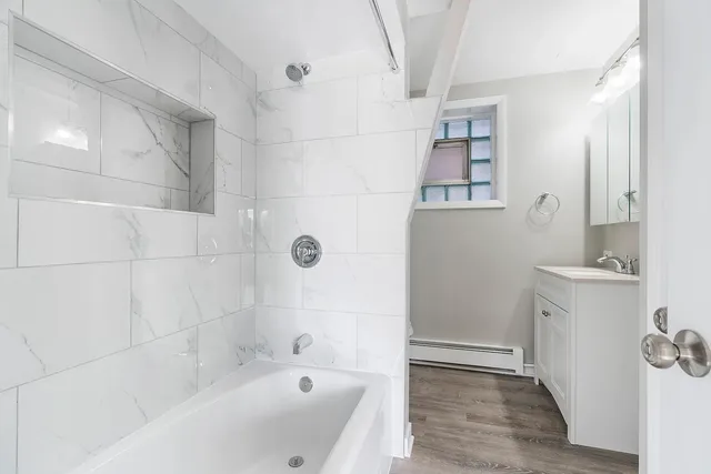 a bathroom with a bathtub and shower