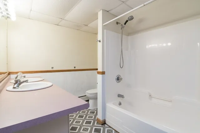 a bathroom with a bathtub a sink and a shower