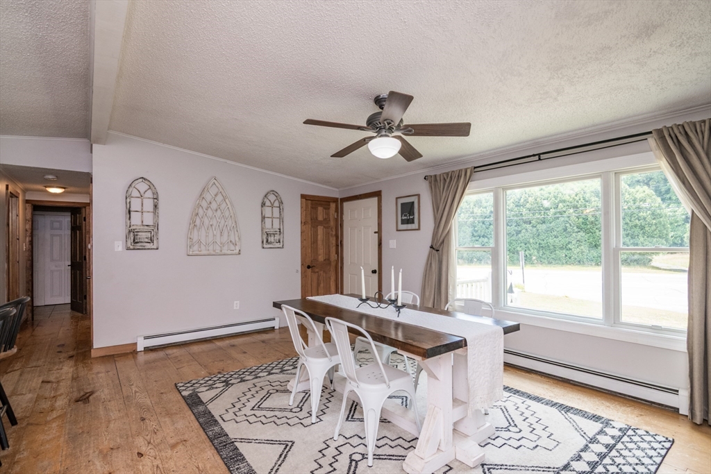 183 Millers Falls Road Montague, MA 01376 - Photo 7 of 33 a dining room with wooden floor and a rug