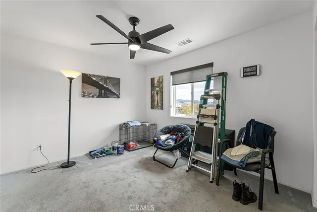 a view of a livingroom with furniture and a window