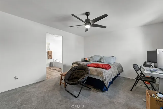a spacious bedroom with a bed and a window