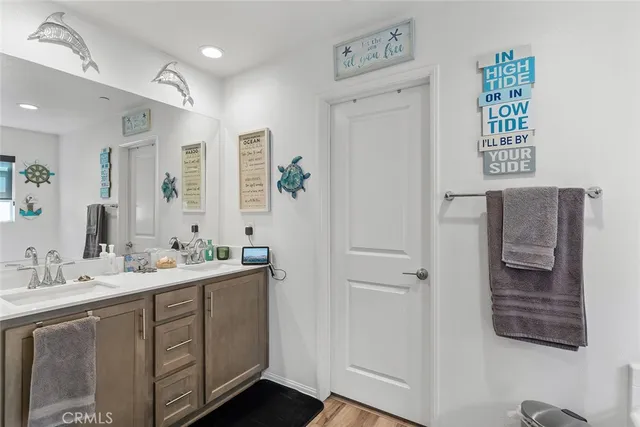 a spacious bathroom with a shower a sink and a mirror