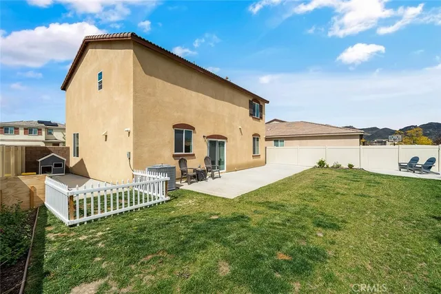 a view of a house with backyard and sitting area