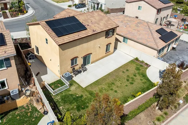 an aerial view of a house with a yard