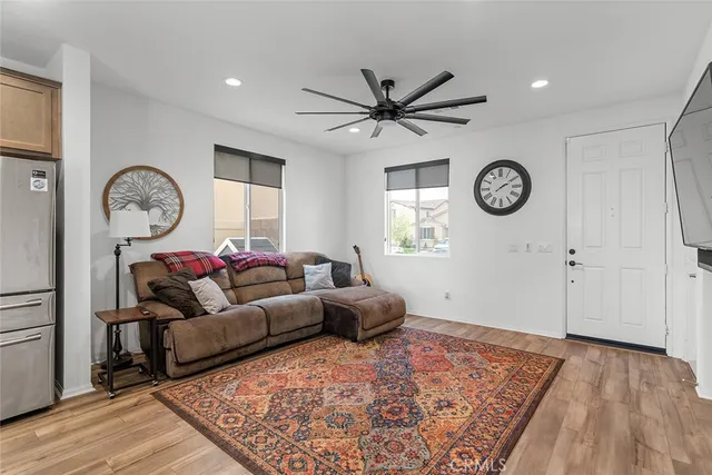 a living room with furniture a clock and a window