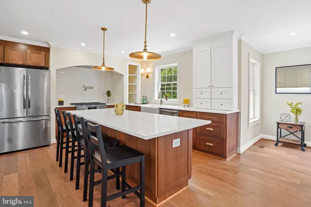 a kitchen with a sink a counter top space appliances and cabinets
