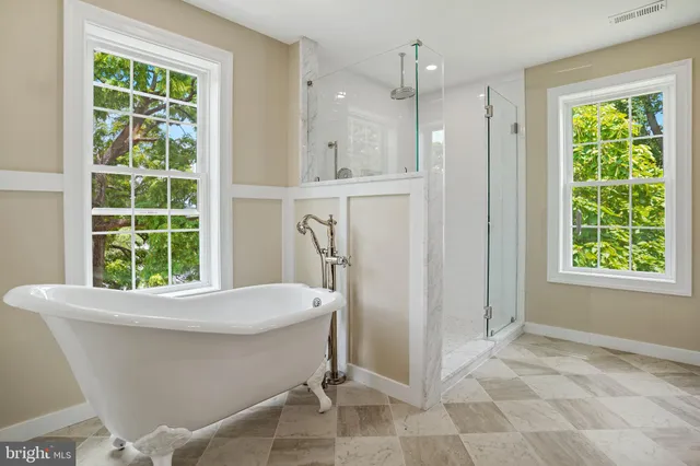 a spacious bathroom with a granite countertop sink mirror and toilet