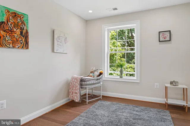 a view of room with toys and wooden floor