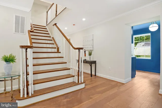 a view of entryway and hall with wooden floor