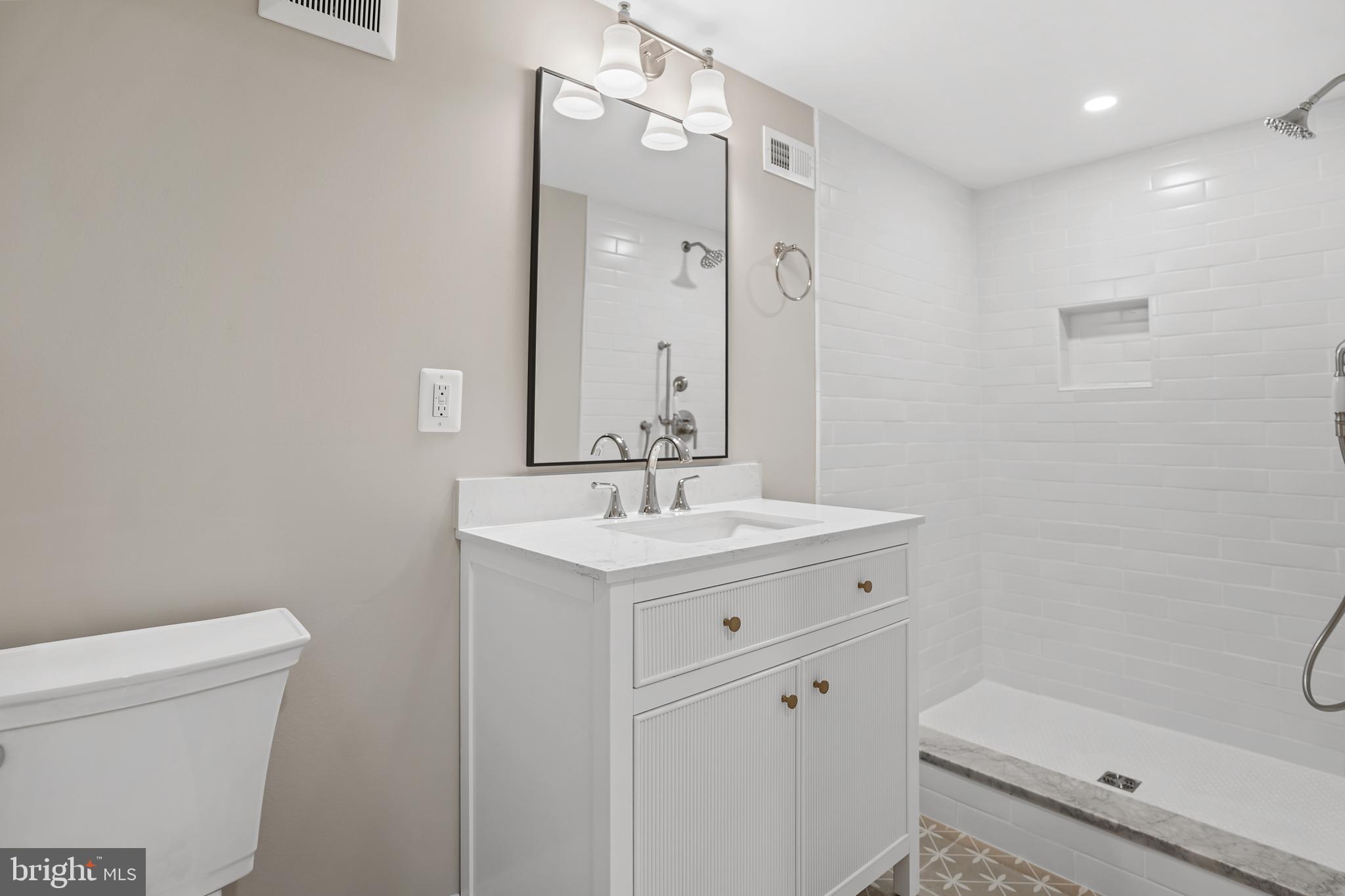 3722 13th Street Northeast Washington, DC 20017 - Photo 43 of 50 a bathroom with a sink a toilet and a mirror