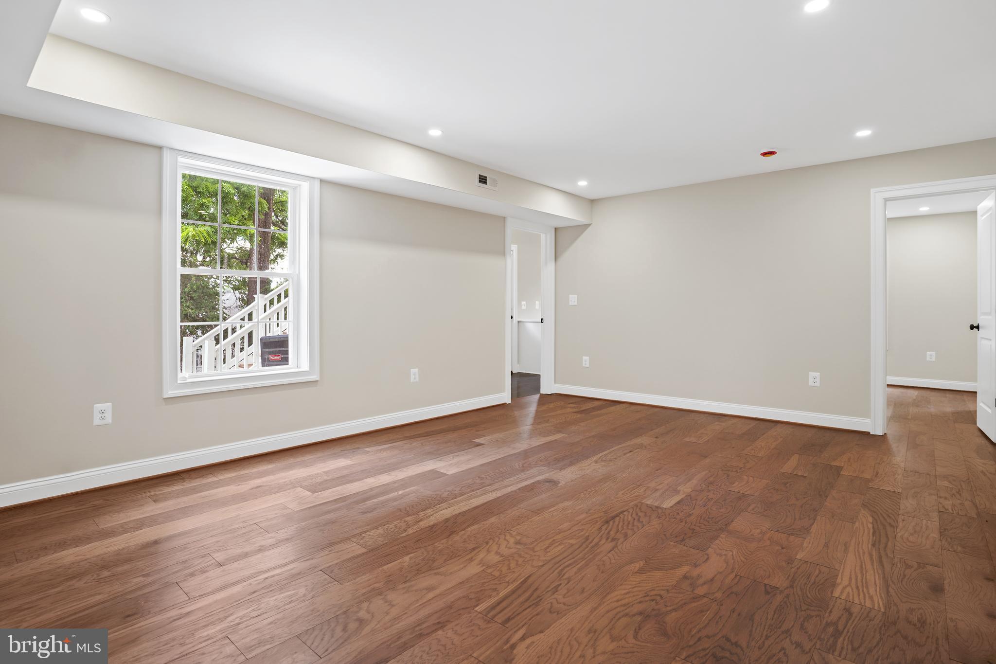 3722 13th Street Northeast Washington, DC 20017 - Photo 44 of 50 a view of an empty room with wooden floor and a window