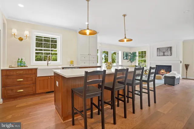a kitchen with stainless steel appliances granite countertop a stove and a wooden floors
