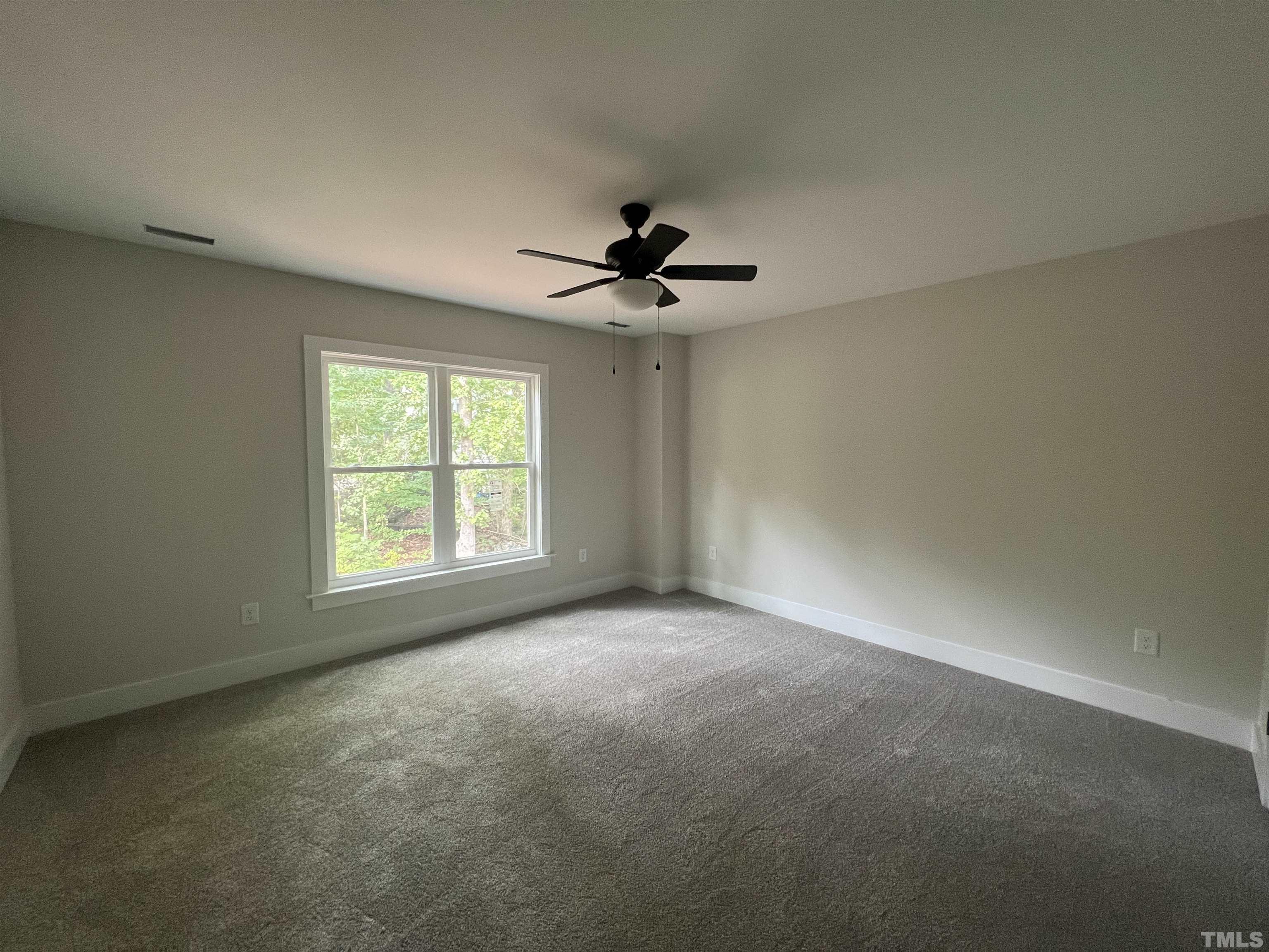 1108 Hammerman Drive Willow Spring, NC 27592 - Photo 11 of 22 an empty room with a ceiling fan and window