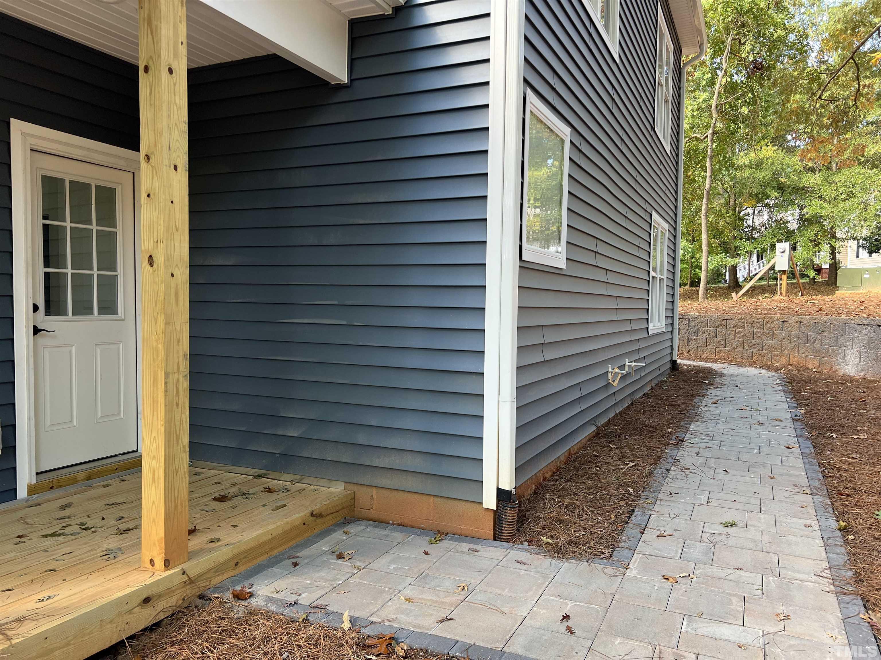 1108 Hammerman Drive Willow Spring, NC 27592 - Photo 17 of 22 a view of a house with a door and wooden walls