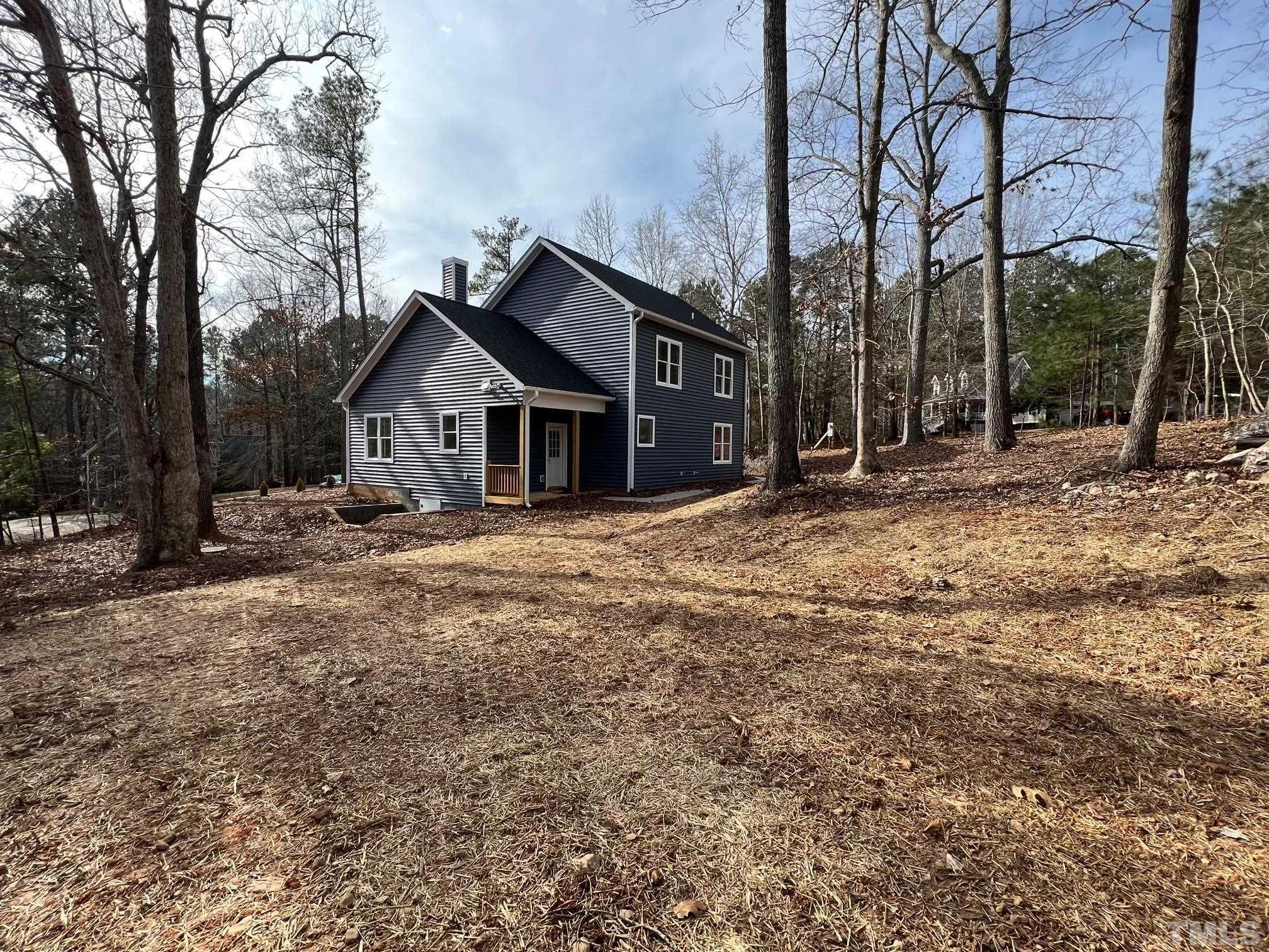 1108 Hammerman Drive Willow Spring, NC 27592 - Photo 20 of 22 a view of a house with a yard covered in snow