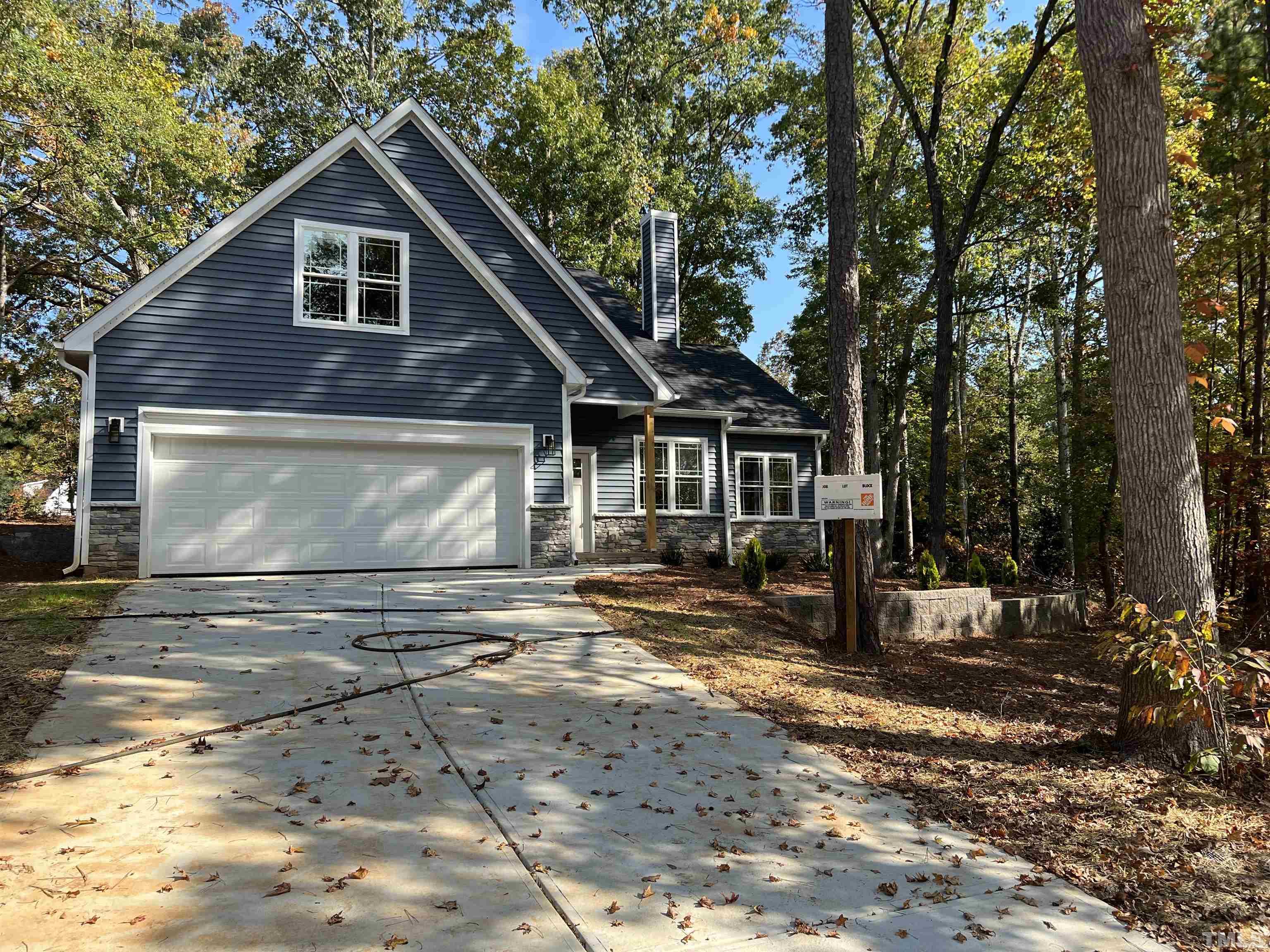1108 Hammerman Drive Willow Spring, NC 27592 - Photo 2 of 22 a front view of a house with a yard