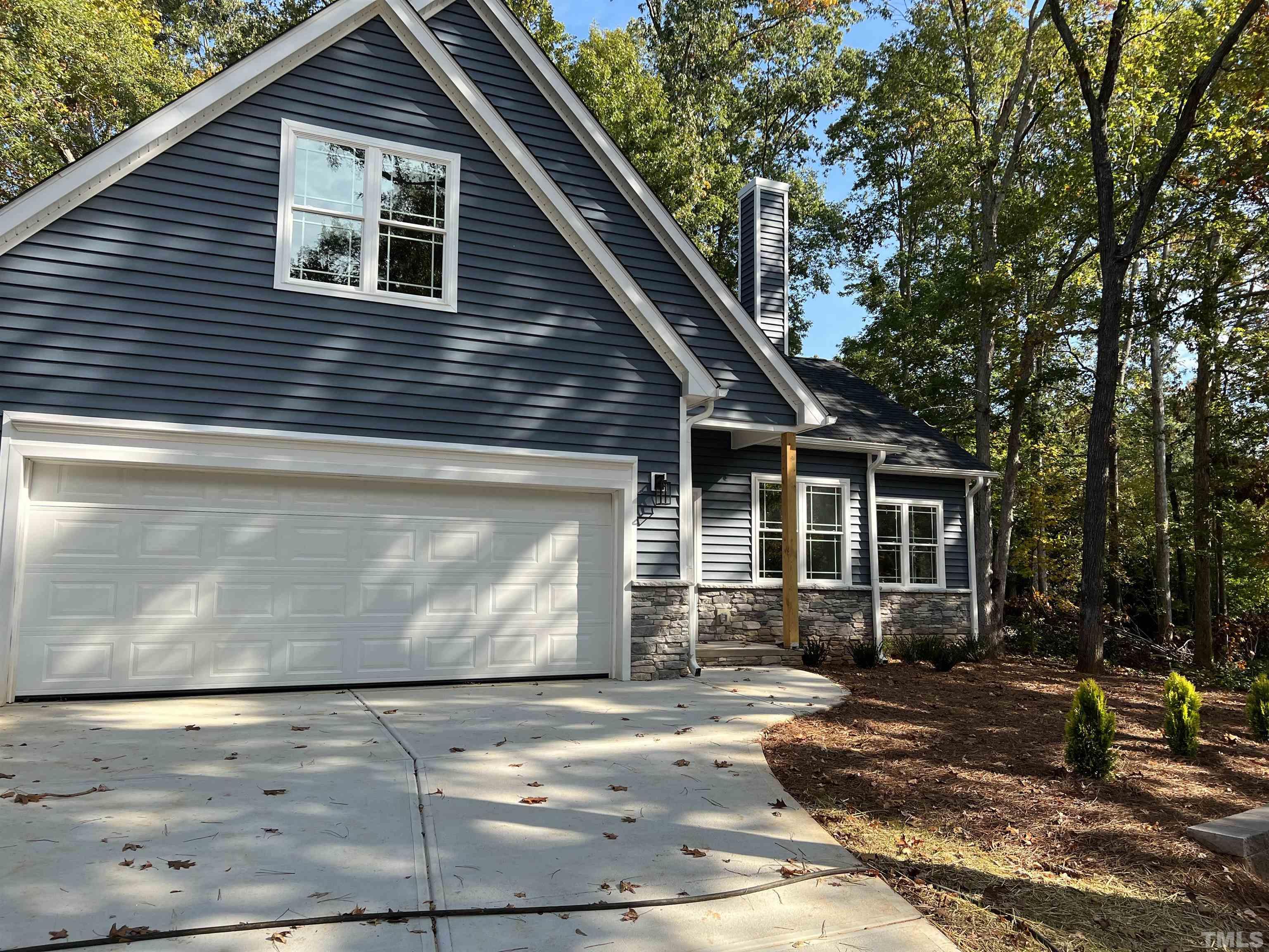1108 Hammerman Drive Willow Spring, NC 27592 - Photo 22 of 22 a front view of a house with garden