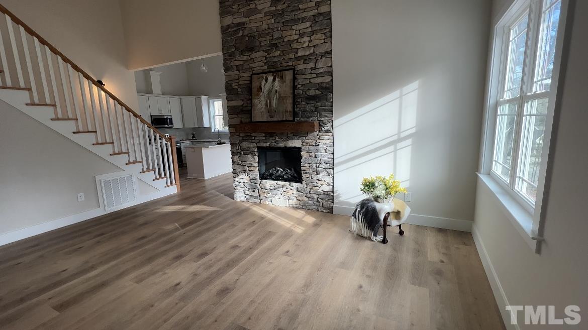 1108 Hammerman Drive Willow Spring, NC 27592 - Photo 3 of 22 a view of main area with wooden floor fireplace and windows