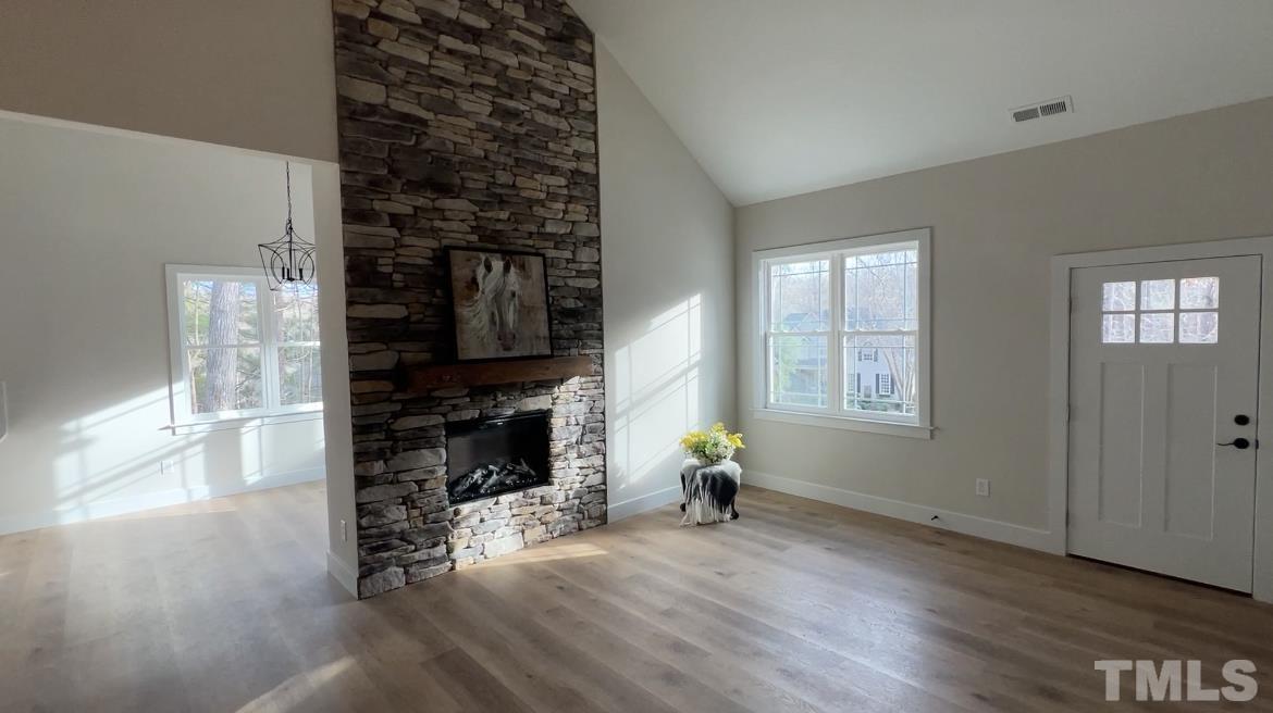 1108 Hammerman Drive Willow Spring, NC 27592 - Photo 4 of 22 a view of empty room with wooden floor and fireplace