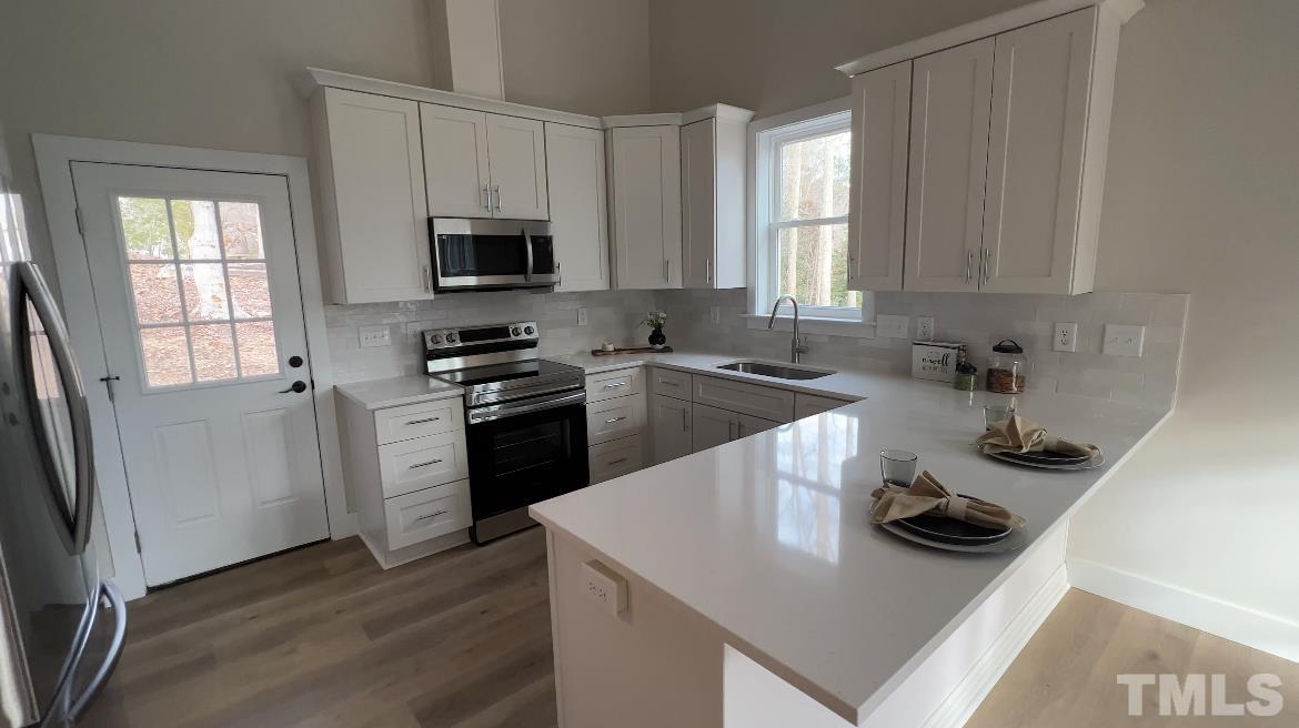 1108 Hammerman Drive Willow Spring, NC 27592 - Photo 5 of 22 a kitchen with a sink a stove and cabinets