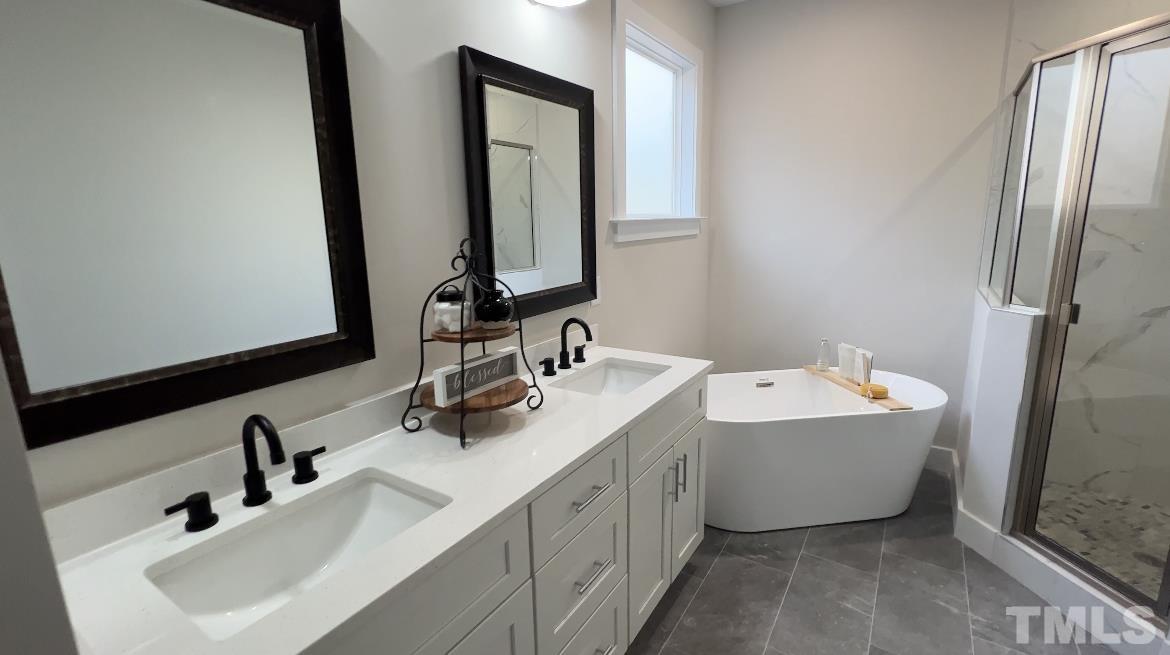 1108 Hammerman Drive Willow Spring, NC 27592 - Photo 7 of 22 a bathroom with a double vanity sink mirror and bathtub