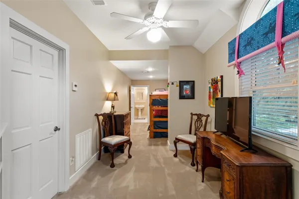 a living room with furniture kitchen view and a large window