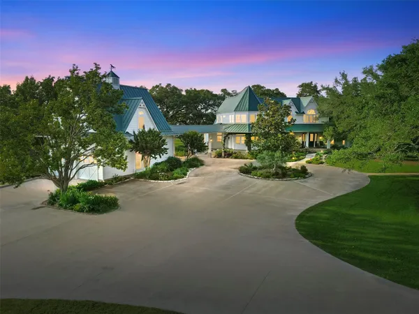 an aerial view of a house with a yard lake lake and outdoor seating
