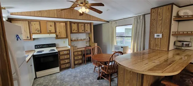a view of a dining room with furniture and a chandelier