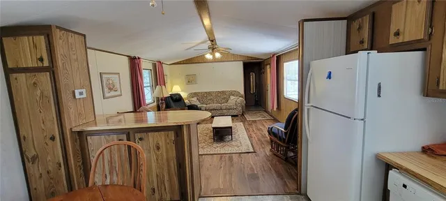 a kitchen with stainless steel appliances granite countertop a refrigerator and a stove