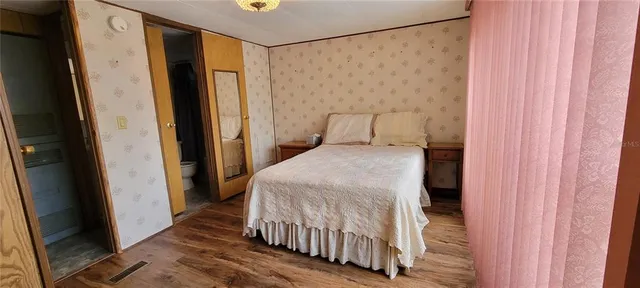 a bedroom with a bed and a mirror